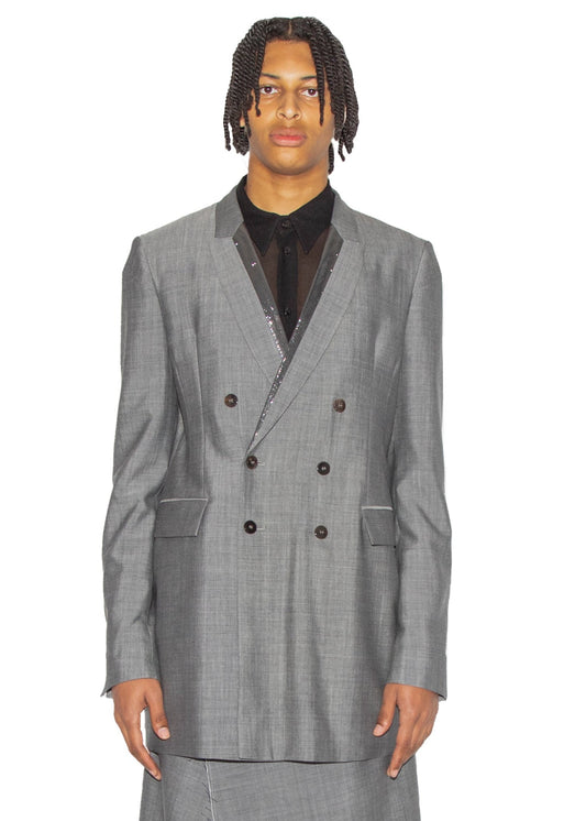 Man wearing a gray checkered suit with a white background